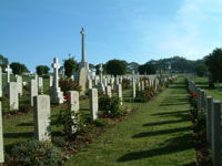 "City cemetery with lines of headstones on a lawn"