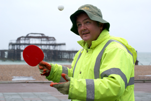 Beach cleaner spending his break playing ping pong
