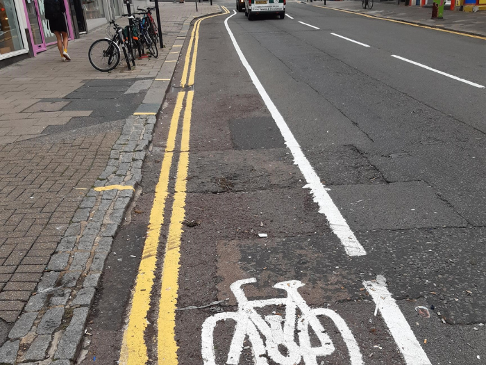 "a road with a painted cycle lane and a painted picture of a bicycle"