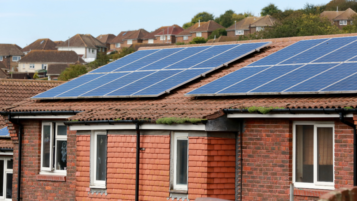 Roofs of domestic houses with solar panels on top