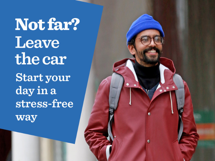 A man in a blue hat and red coat walking with the words 'Not Far? Leave the car, start your day in a stress-free way'