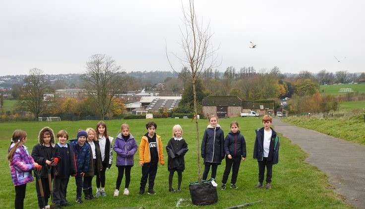 Pupils from Balfour Primary School planting a tree on the Surrenden campus
