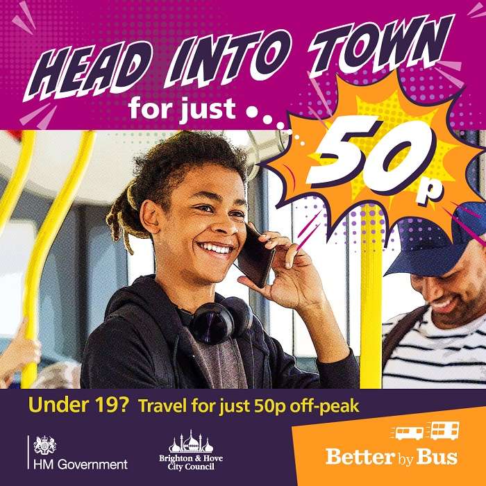 A young person on a bus holding his phone to his ear