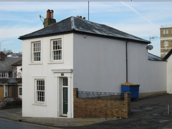 Image of Alma Cottage, South Street, Portslade. A white house with a slanted roof.