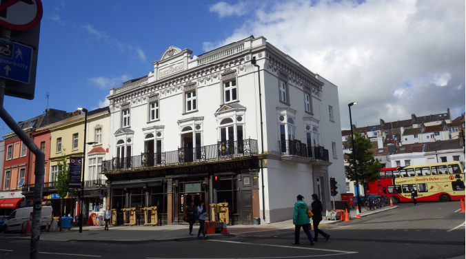 Image of Queen's Head on Queen's Road. A large white building.