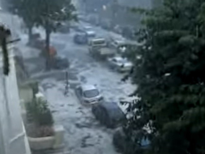 A flooded roads with cars partly submerged