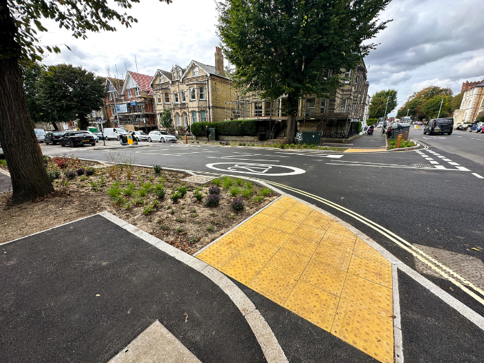 A road junction with pavement and planting