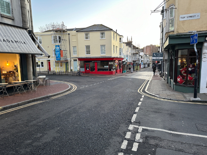 A picture of a road and two junctions, with shops on either side