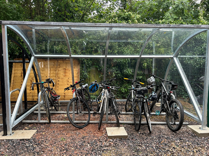 A picture of a cycle shelter with bikes in it