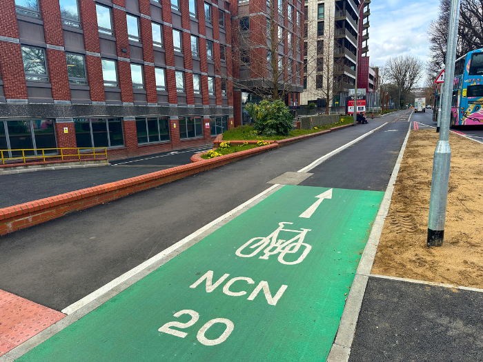 An image of a cycle lane next to a pavement and large building