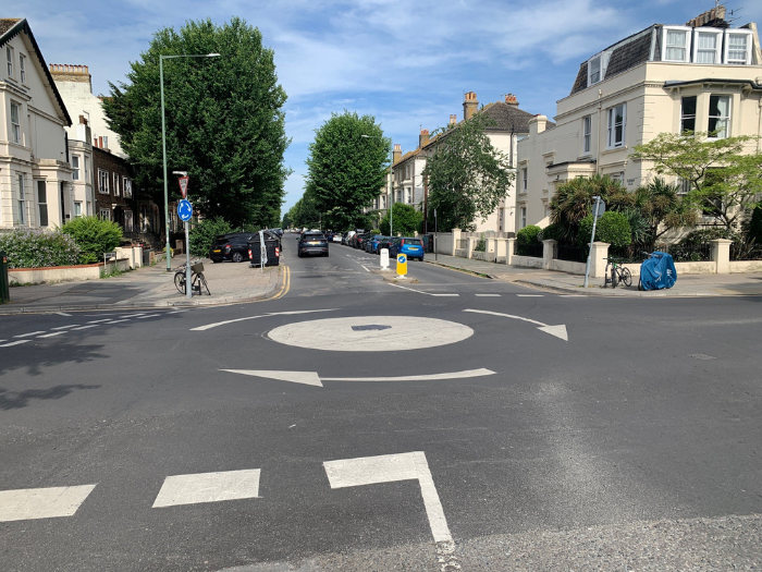 A picture of a mini roundabout on a junction
