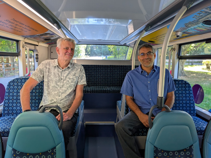 Two people sitting on a bus