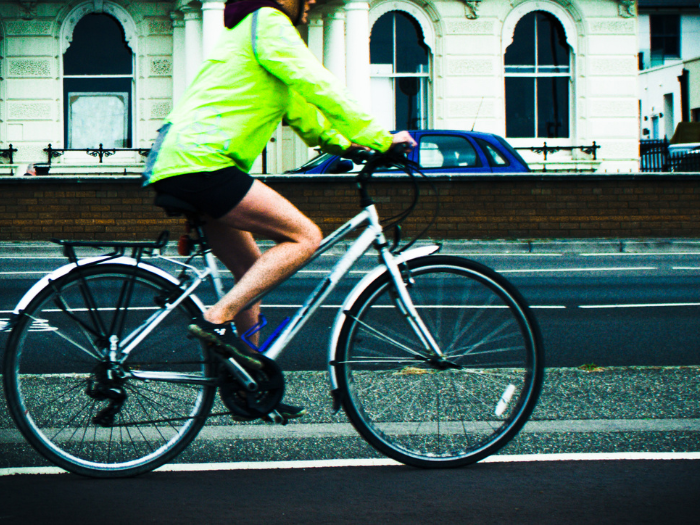 a person in a hi vis jacket riding a bike