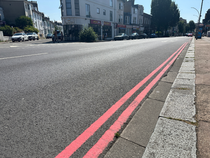 A picture of a road with two red lines 