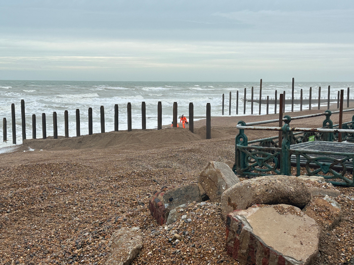 A picture of a beach and timber groynes
