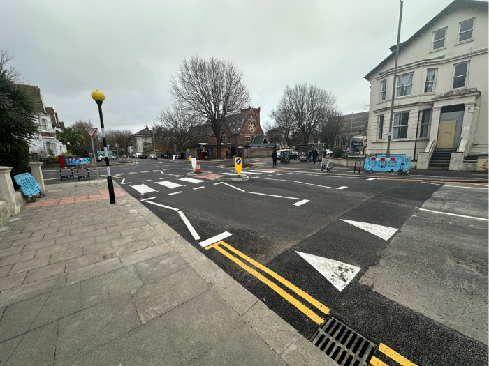 a picture of a road junction with zebra crossing