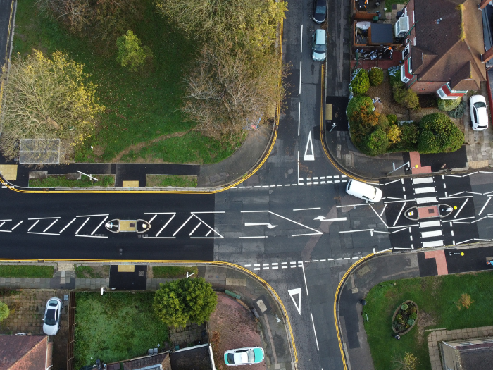 A drone picture of a road junction with zebra crossing