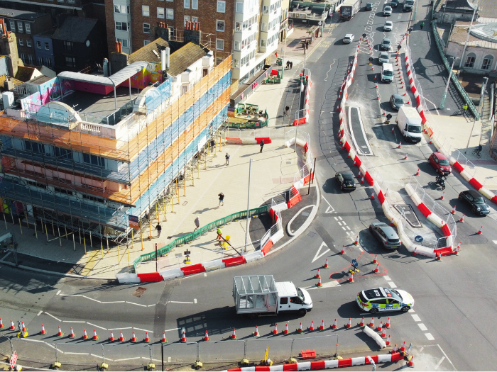 roads and a newly laid pavement with buildings surrounding it