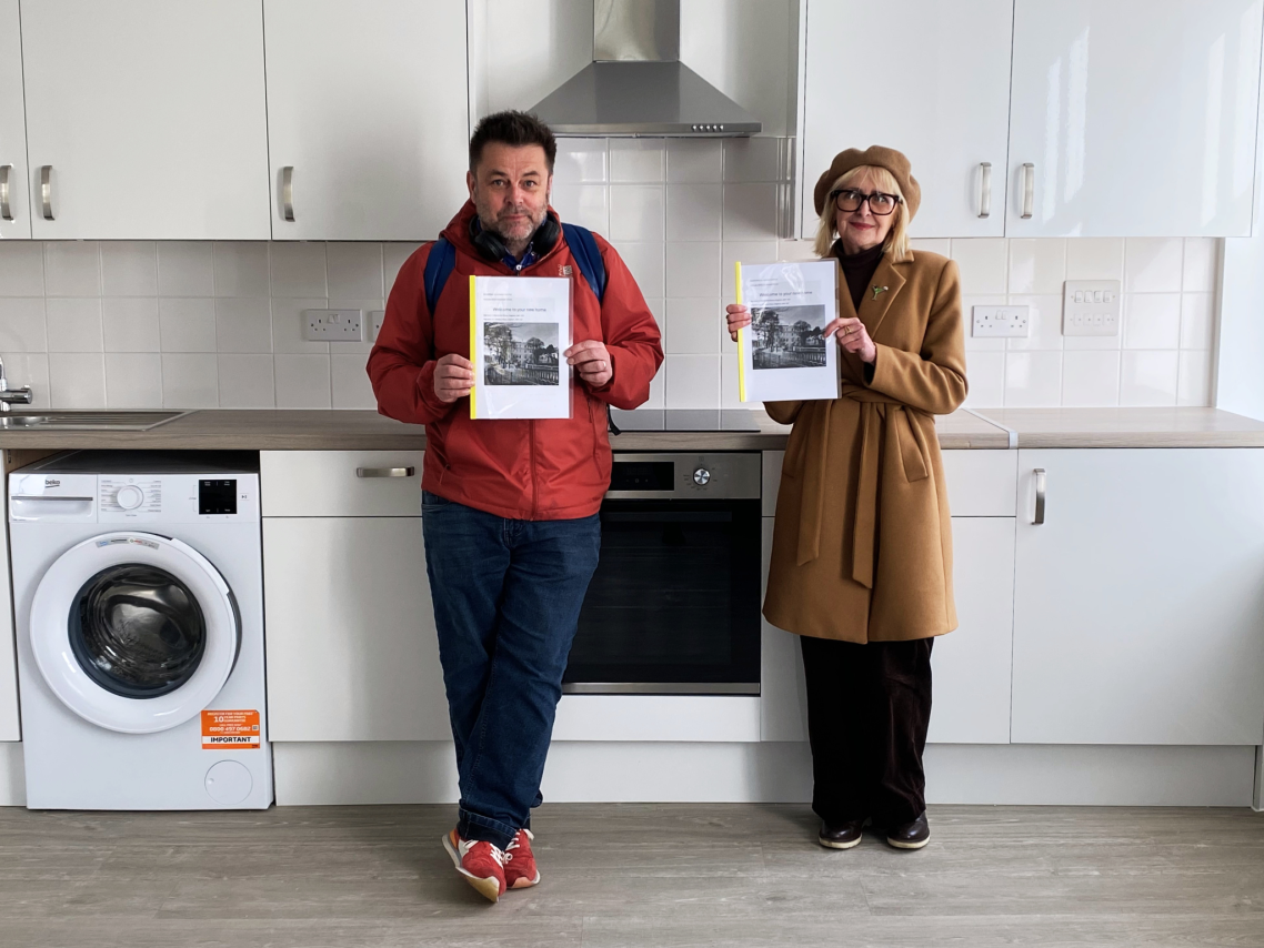 Cllr Gill Williams and Cllr Paul Nann standing together in a clean, modern kitchen..