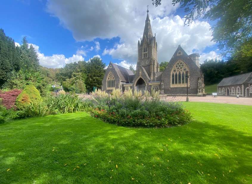 Woodvale crematorium with green lawns and flower beds.