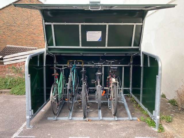 A cycle hanger with the side open, visible is the stand for bikes, with 5 bikes already safely stored inside.