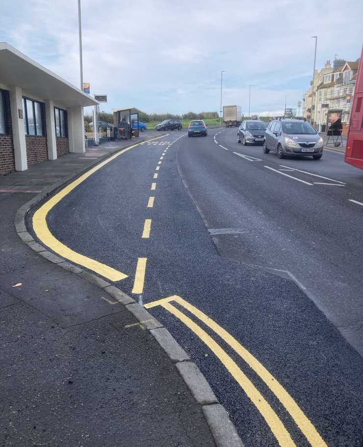 Photograph of a road that's been machine patched.
