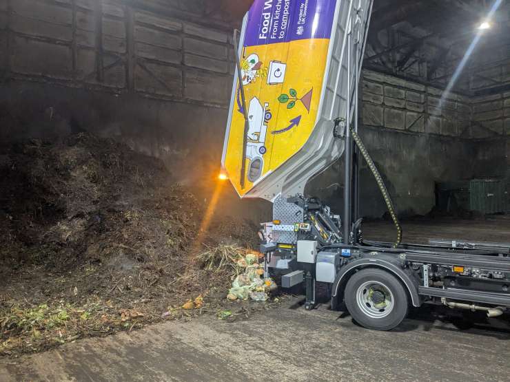 Photograph showing a food waste truck tipping in the composting facility