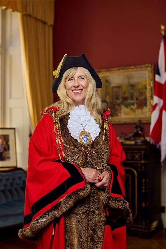 Photograph of Mayor Fowler in dress robes standing in the Mayors Parlour.