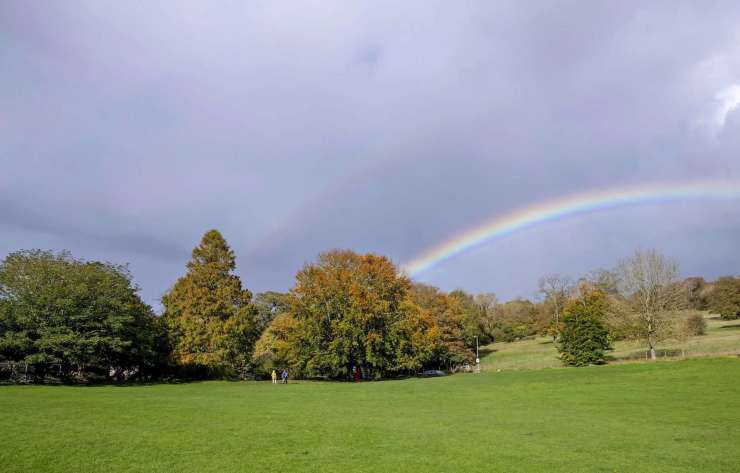 A rainbow over the countryside setting of Stanmer Park.
