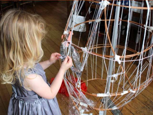 Small child making a sculpture in Brighton Museum