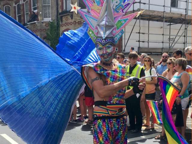 Pride parade participant in rainbow colours