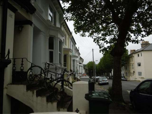 A tree-lined street of houses in Brighton (Beaconsfield Road)
