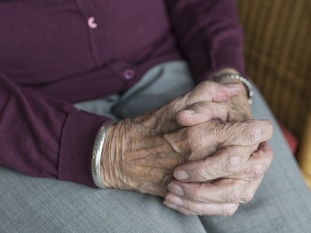 Older person's clasped hands