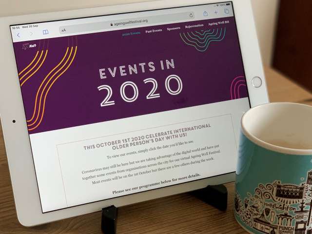 photo of an ipad with the Ageing WEll festival programme on it and a cup of tea