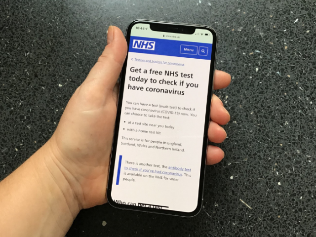 Smartphone showing the NHS app for booking covid tests