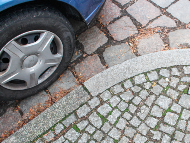 Car wheel parked on a pavement area