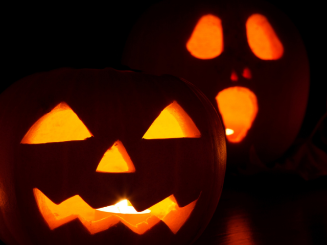 Photo of two pumpkins carved with faces for Halloween