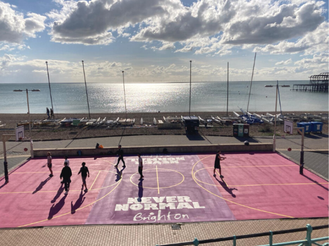 Seafront basketball court at sunset