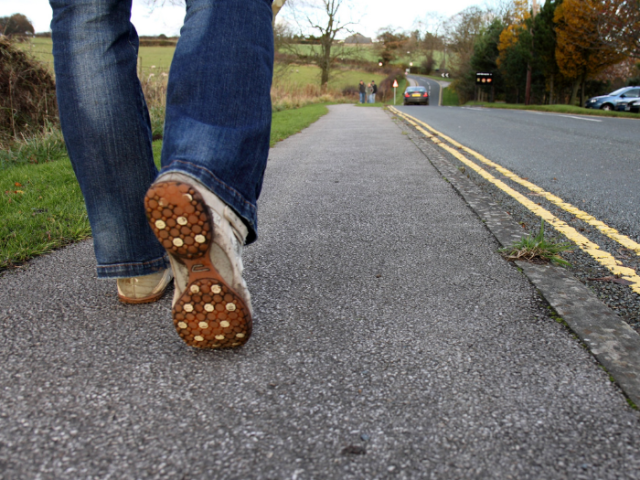 Picture of person walking on a pavement