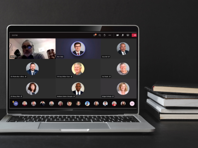 A picture of a laptop showing a virtual council meeting