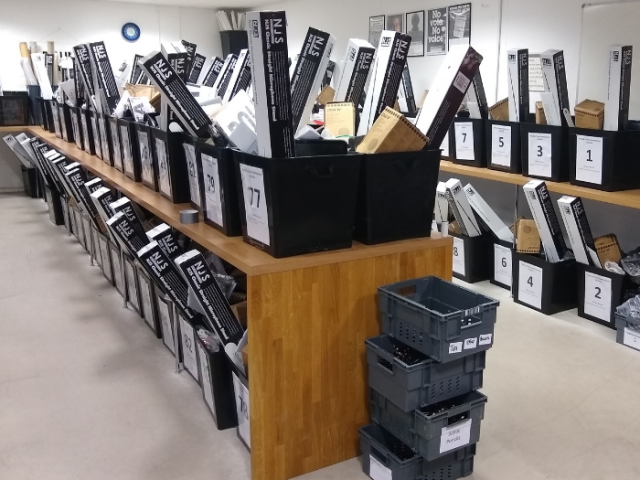 Rows of ballot boxes being filled with items for the election