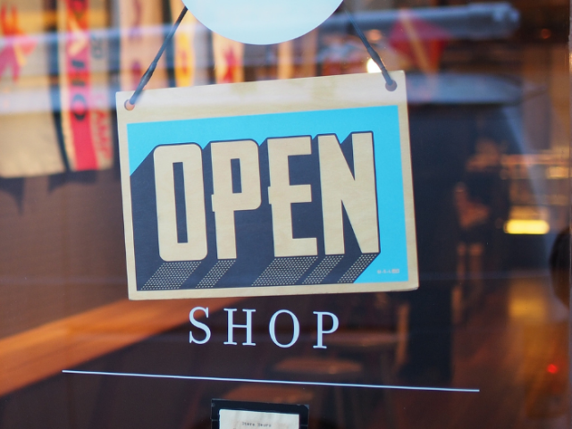 Picture of a shop sign reading 'Open'