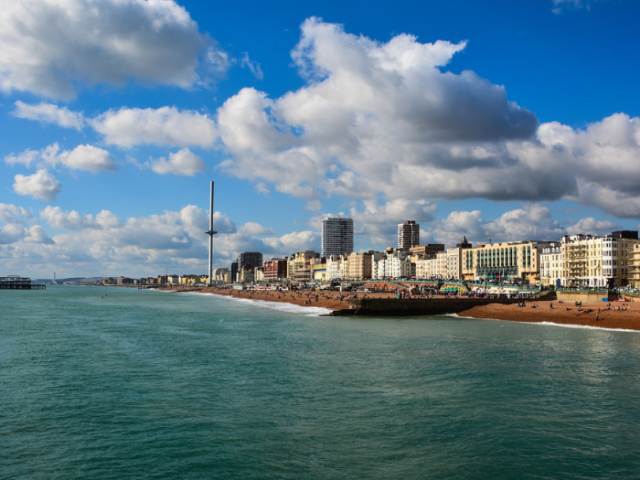 Picture of Brighton seafront including the sea, beach and buildings