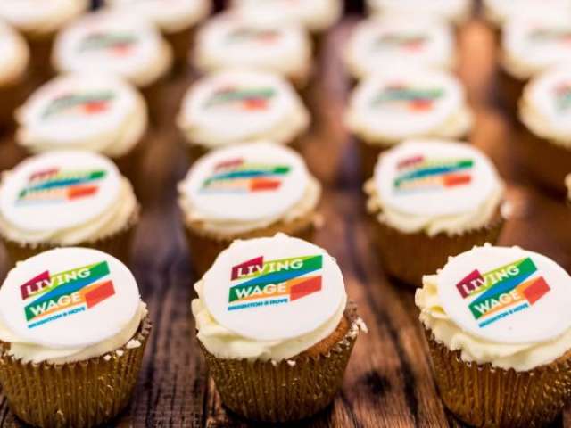 Rows of cup cakes iced with the words: "Living Wage Brighton & Hove"