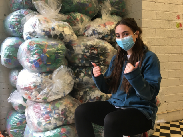 Picture of a Green Centre volunteer with bags of recycling