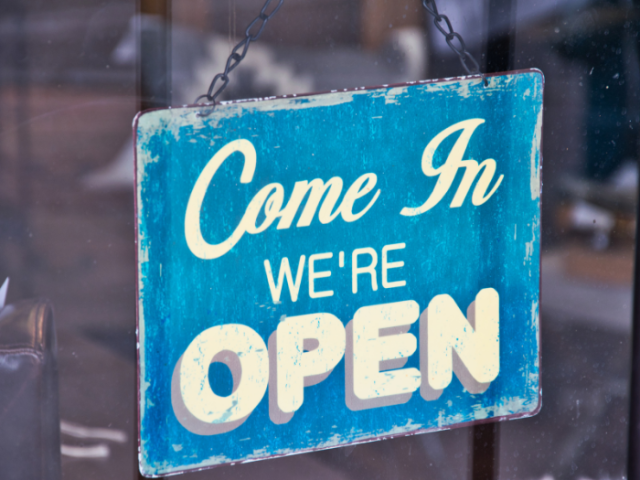 A picture of a shop sign reading 'come in, we're open'