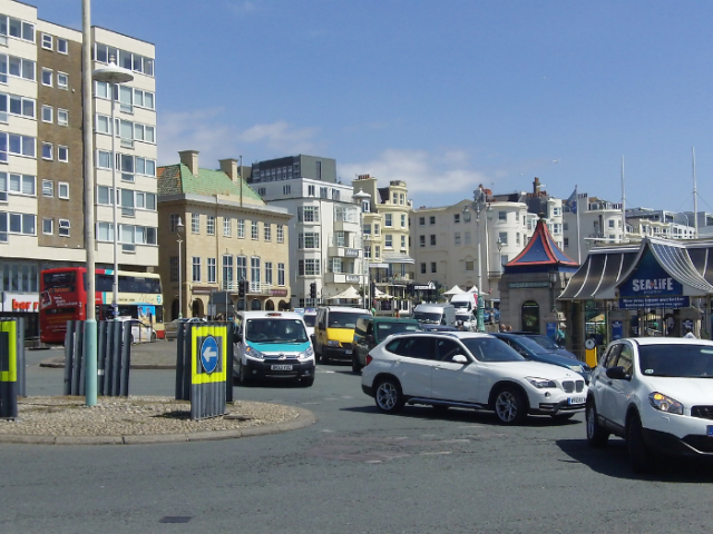 A picture of cars moving around a roundabout 