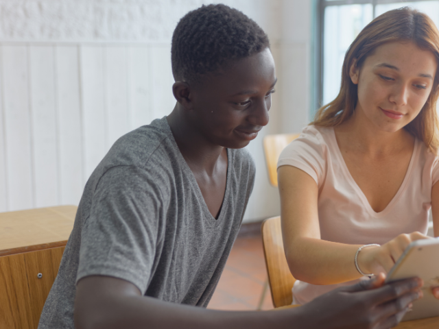 teenagers looking at a laptop screen