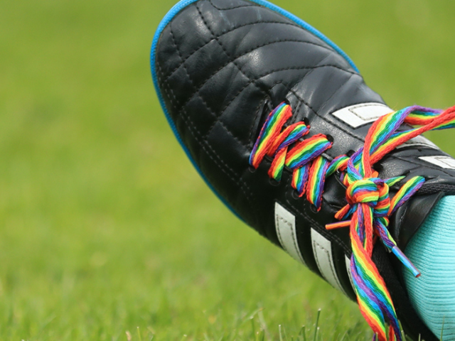 Picture of a football boot with rainbow laces
