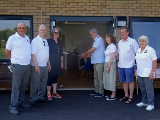 The mayor, Councillor Alan Robin, cutting the ribbon at the official opening of the new sports pavilion in Victoria Recreation Ground, with housing co-chairs Councillor Siriol Hugh-Jones and Councillor David Gibson and members of the Portslade Bowls Club.